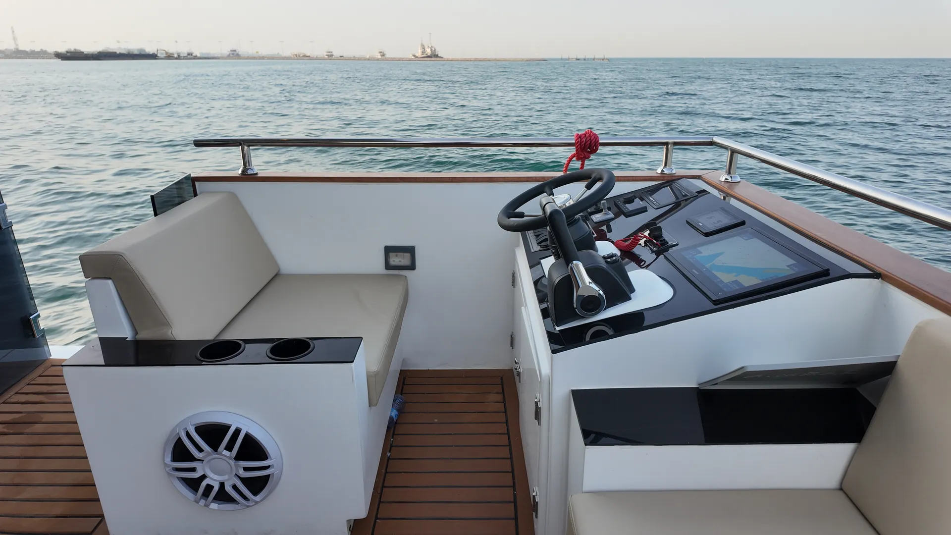 AQUATOR 50 helm on the flybridge, with a bench seat and the sea ahead