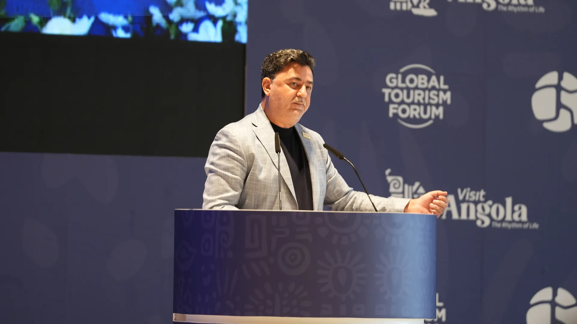 Wael Joujou, V-Marine’s founder, speaking at a lectern at the Global Tourism Forum Angola Investment Summit 2026, with Visit Angola branding on the stage