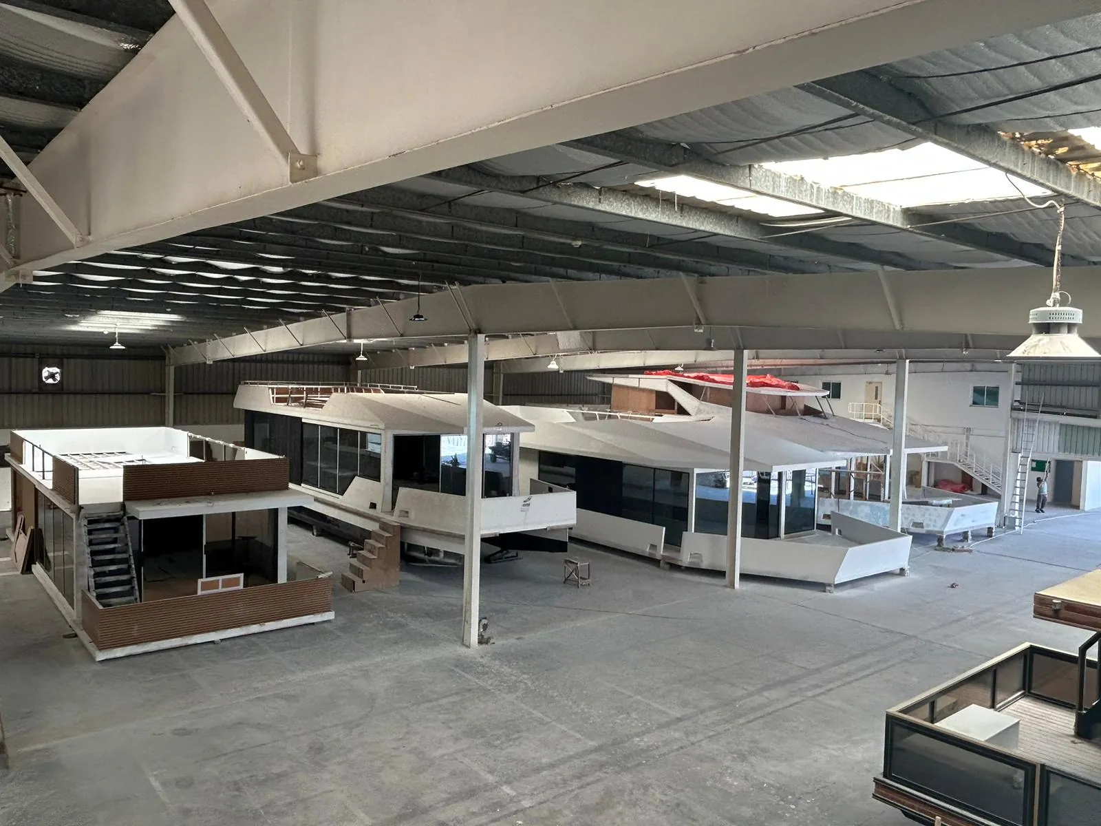 Yachts and a floating structure taking shape side by side in the V-Marine production hall in Bahrain