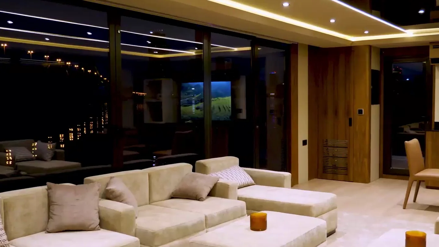 The majlis lounge in the evening, lit by cove lighting along the ceiling