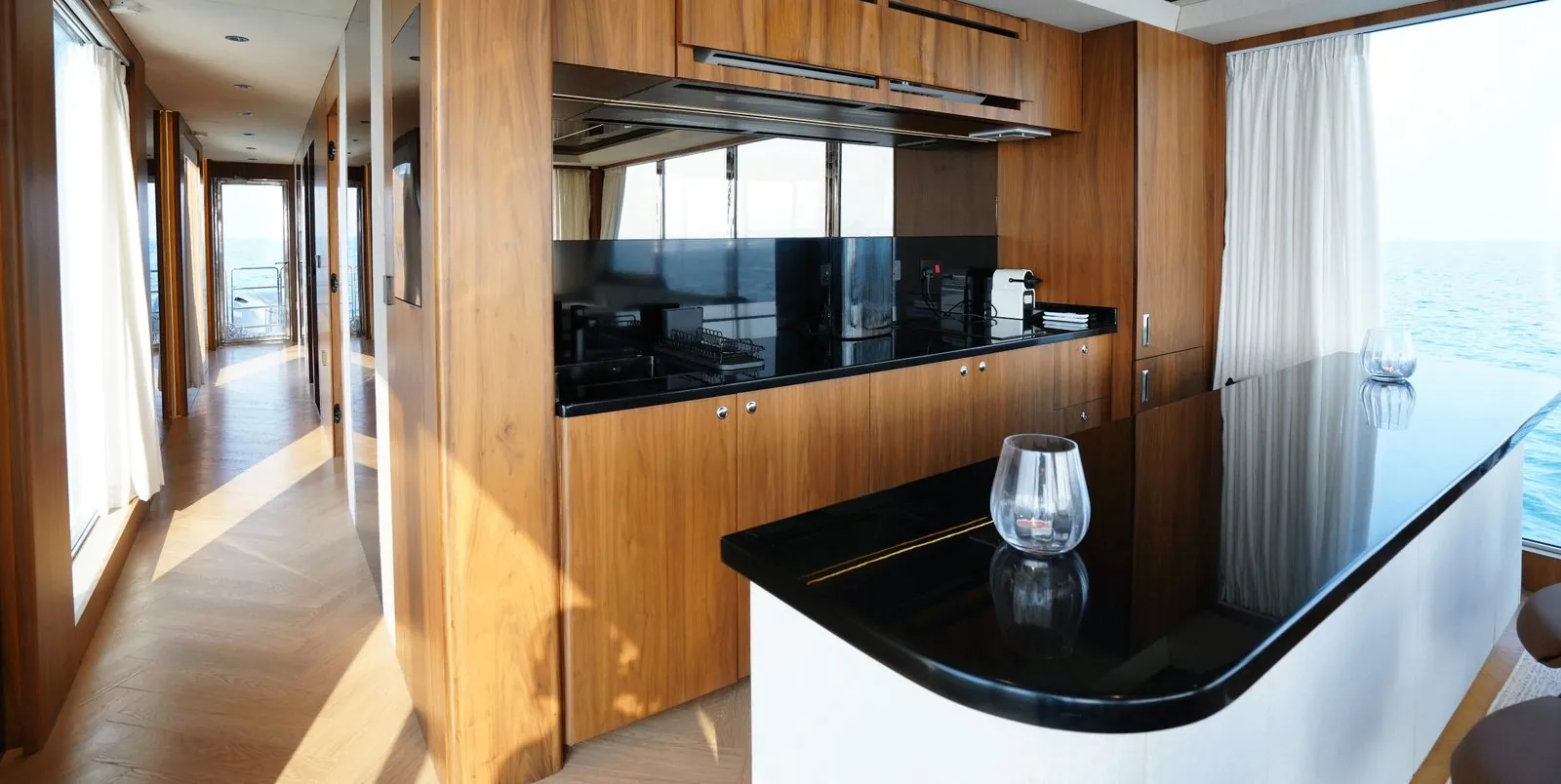 RISE 60 galley with walnut cabinetry and a black stone counter