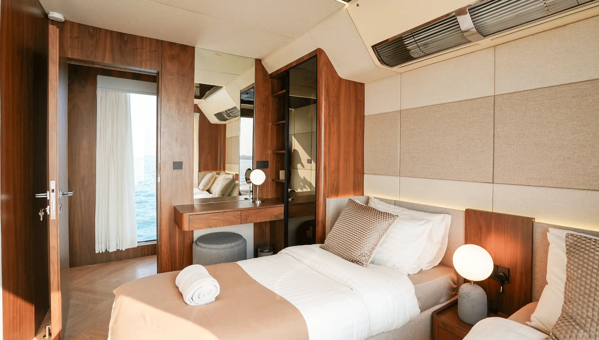 RISE 70 guest cabin with twin beds and a vanity