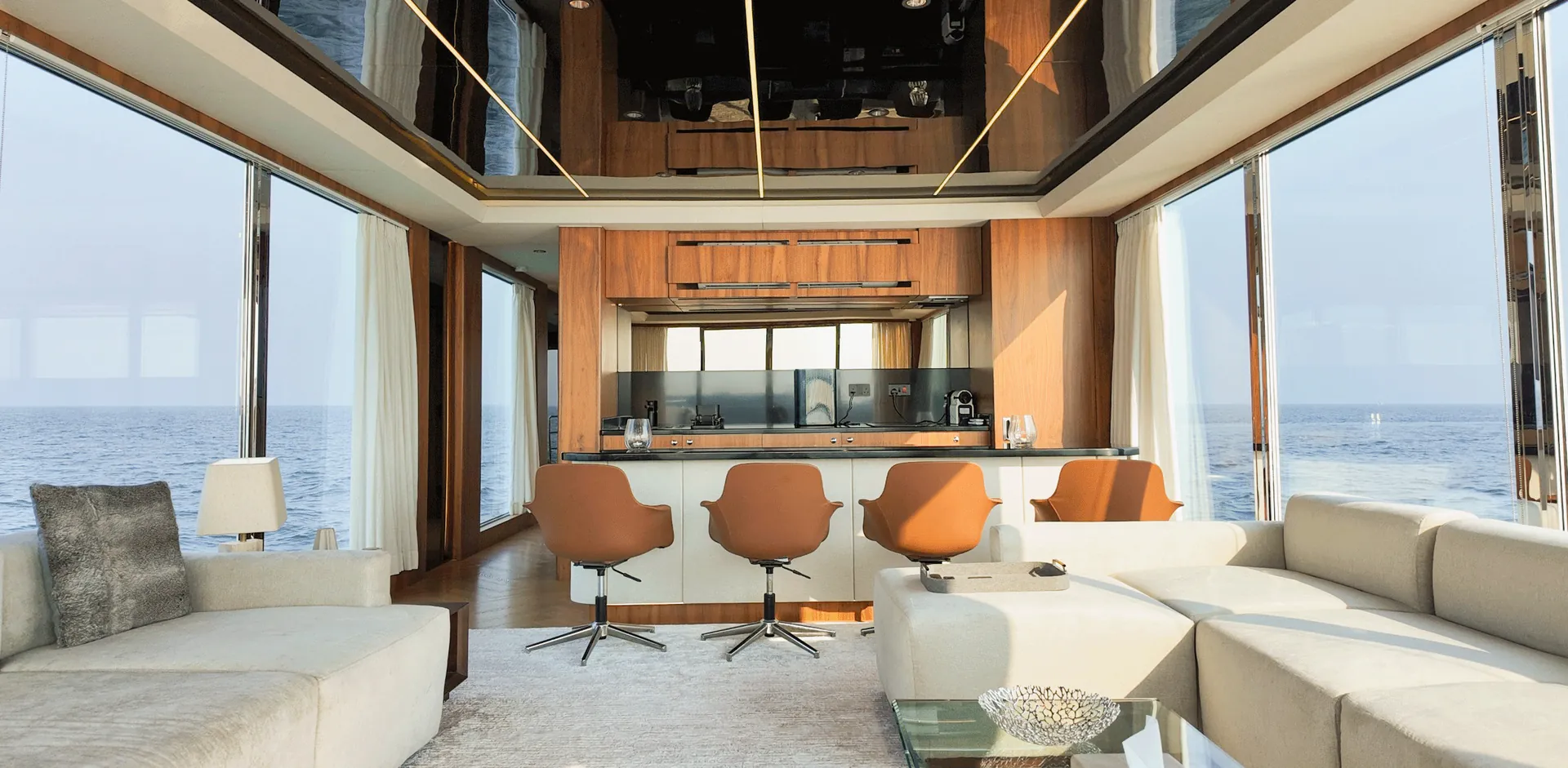 RISE 70 saloon with lounge seating, a counter with leather stools and panoramic glass