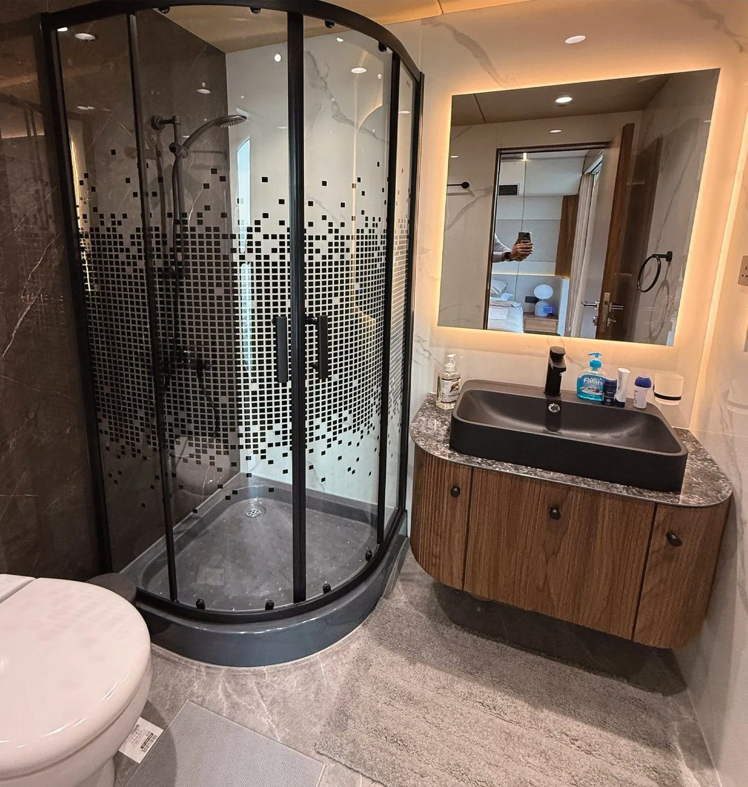 RISE bathroom with a glass shower and a stone vanity